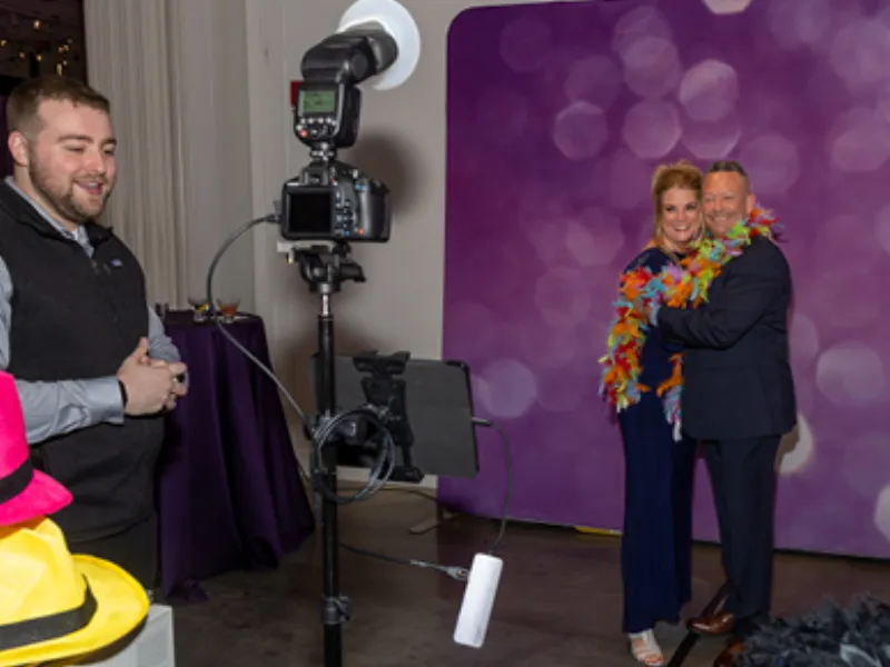 Friends posing at the HD Tripod Pro booth with green screen